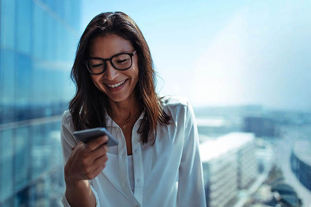 woman booking an eye exam on mobile
